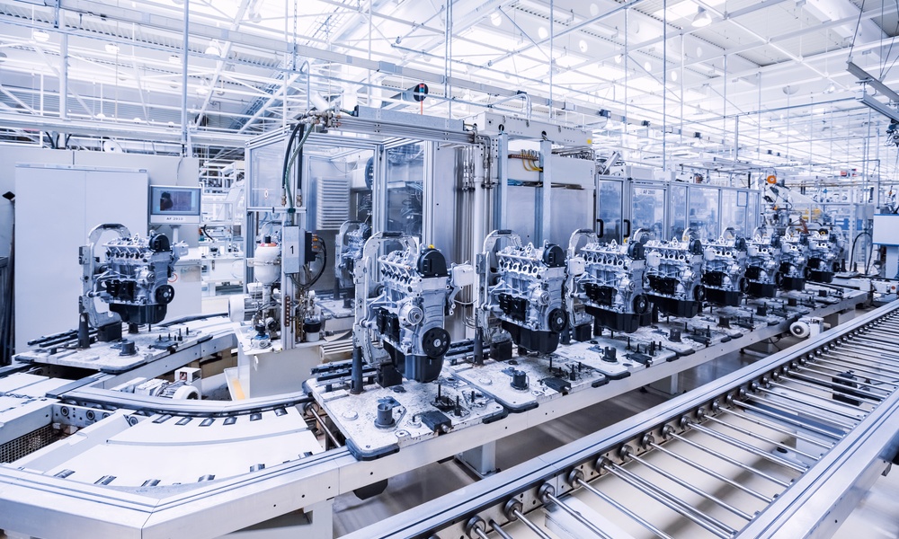 A fully automated car engine production line, run by AI and robotics. The production line curves at the left end.
